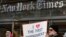FILE - Protesters hold signs during a show of solidarity with the press in front of The New York Times building, Feb. 26, 2017, in New York. 