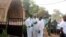 FILE - Health officials stand outside La Terrasse restaurant in Bamako, where five people were killed in a militant attack, March 7, 2015. 