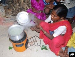 This woman in India uses a cookstove developed by Willson's team that produces less smoke for burning wood or any other fuel.