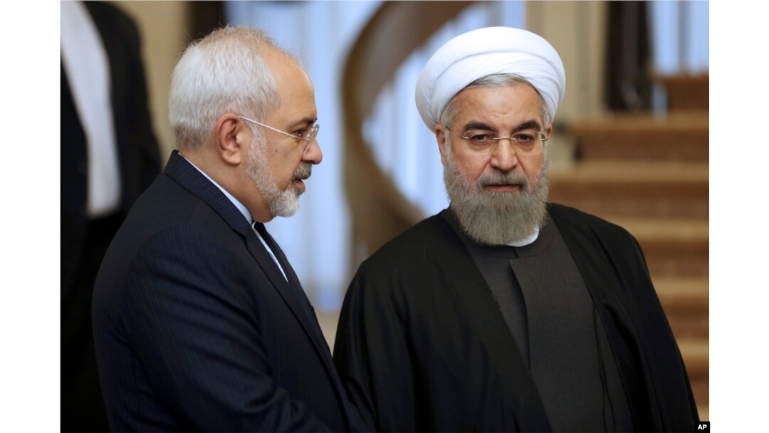 FILE - Iranian President Hassan Rouhani, right, listens to Foreign Minister Mohammad Javad Zarif before a meeting in Tehran, Iran, Nov. 24, 2015.
