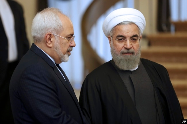 FILE - Iranian President Hassan Rouhani, right, listens to Foreign Minister Mohammad Javad Zarif before a meeting in Tehran, Iran, Nov. 24, 2015.