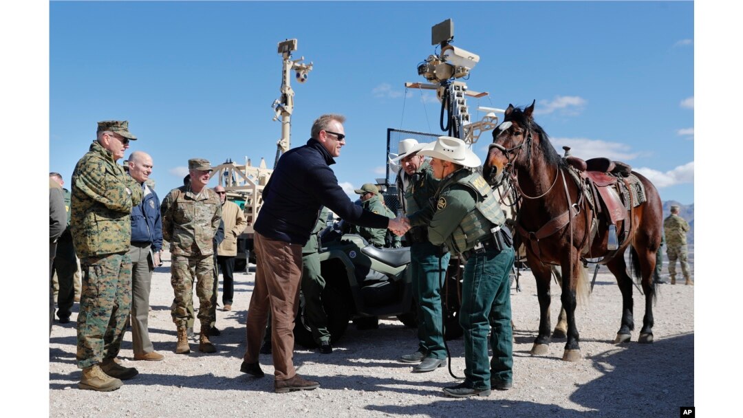 Acting Secretary of Defense Patrick Shanahan, center, greets Border Patrol Agents Carlos Lerma, second from right, Moises Gonzalez, right, and the horse they use for patrols during a tour of the U.S.-Mexico border at Santa Teresa Station in Sunland Park, N.M.