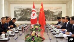 China's Foreign Minister Wang Yi, second from right, speaks as Tunisia's Foreign Minister Khemaies Jhinaoui, second from left, listens during a meeting at the Ministry of Foreign Affairs in Beijing, July 19, 2017.