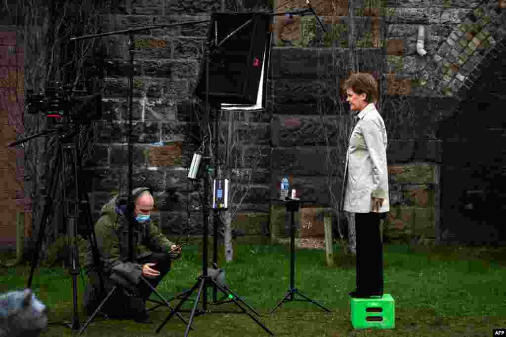 Scotland&#39;s First Minister and leader of the Scottish National Party (SNP), Nicola Sturgeon, waits for the camera technician as she launches the SNP virtual electoral campaign in Partick in the West End of Glasgow.