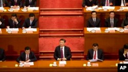 Chinese President Xi Jinping (center) listens during the opening session of the Chinese People's Political Consultative Conference in Beijing's Great Hall of the People, March 3, 2017.