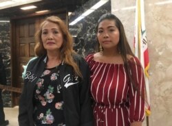 FILE - Savun Yong, left, mother of Borey Ai, and his sister-in-law, Jennie Ou, right, pose while attending a rally by advocacy groups calling for California Gov. Jerry Brown to grant pardons to Ai and others facing deportation to Cambodia, Oct. 24, 2018.