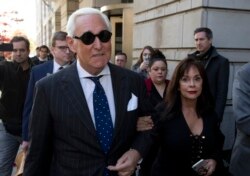 FILE - In this Nov. 15, 2019, file photo, Roger Stone, left, with his wife Nydia Stone, leaves federal court in Washington, Nov. 15, 2019.