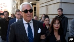  In this Nov. 15, 2019, file photo, Roger Stone, left, with his wife Nydia Stone, leaves federal court in Washington, Friday, Nov. 15, 2019.