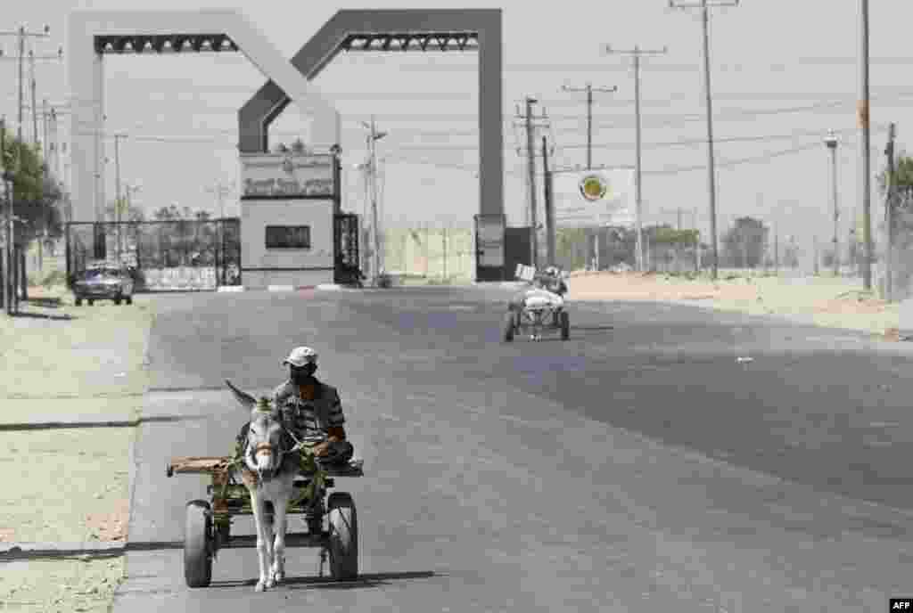 A Palestinian man rides a donkey cart outside the Rafah border crossing between southern Gaza Strip and Egypt, Monday, Aug. 6, 2012. Egypt has closed the terminal.