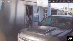 This Sept. 14, 2019 image from video released in a U.S. Attorney detention memorandum shows Brian Mark Lemley Jr., driving, and Patrik Mathews, passenger seat, passing through a toll booth near Norfolk, Va., en route to Georgia.