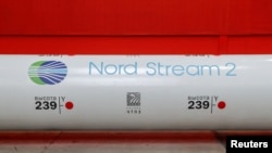 FILE - The logo of the Nord Stream 2 gas pipeline project is seen on a large diameter pipe at the Chelyabinsk Pipe Rolling Plant owned by ChelPipe Group in Chelyabinsk, Russia, Feb. 26, 2020.