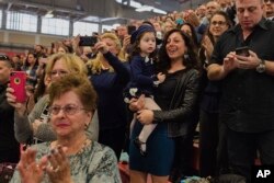 Matias Ferreira's wife, Tiffany (center right), celebrates with her daughter, her mother (bottom left) and her father (top right) during Matias' graduation.