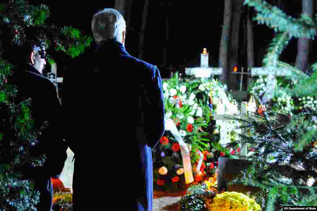 U.S. Secretary of State John Kerry chats with Michal Mazowiecki, the son of former Polish Prime Minister Tadeusz Mazowiecki, after paying his respects at the father's gravesite in Laski Cemetery outside Warsaw, Poland, on November 4, 2013. 