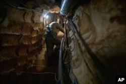 FILE - An Israeli soldier climbs the stairs inside a tunnel that the army says crosses from Lebanon to Israel, near Zarit, Israel, on Dec. 16, 2021. The army says the Hezbollah tunnel was discovered in 2019 and later was sealed.