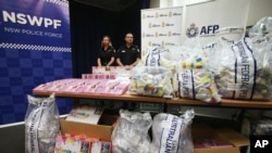 FILE - Officers stand by a display of confiscated drugs in Sydney, Monday, Jan. 15, 2016.