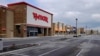 An empty parking lot is seen as retail stores are closed April 15, 2020, in Whitestown, Indiana. Evidence of the devastating impact of the coronavirus on the U.S. economy has been steadily emerging. 