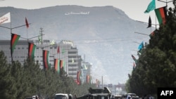 Taliban fighters block a road with a Humvee vehicle near Kabul airport in Kabul on August 28, 2021, following the Taliban stunning military takeover of Afghanistan. (Photo by WAKIL KOHSAR / AFP)