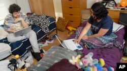 FILE - Students surf the internet in their dorm room at Wesleyan University in Middletown, Conn., April 24, 2008.