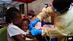 FILE - A child is vaccinated against Ebola in Beni, Congo, July 13, 2019.