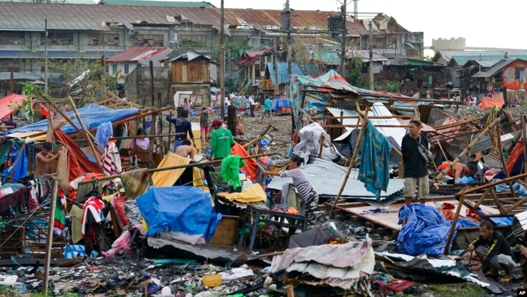 Warga menyelamatkan sisa-sisa rumah mereka yang rusak akibat Topan Rai di Kota Cebu, Filipina tengah pada 17 Desember 2021. (Foto: AP)