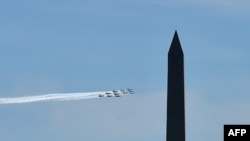 The U.S. Navy Blue Angels and U.S. Air Force Thunderbirds fly over Washington, D.C., as seen from Arlington, Virginia, in a tribute to essential workers during the coronavirus pandemic, on May 2, 2020.
