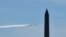 The U.S. Navy Blue Angels and U.S. Air Force Thunderbirds fly over Washington, D.C., as seen from Arlington, Virginia, in a tribute to essential workers during the coronavirus pandemic, on May 2, 2020.