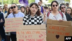 A protestor holds a placard reading "'There's rape and rape' and there's my hand in your face" during a demonstration in support of Gisele Pelicot in Rennes, France, Sept. 14, 2024. 