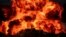 An explosion is seen behind a soldier during a joint exercise called the 'Great Prophet 17', in the southwest of Iran, in this picture obtained on Dec. 22, 2021.