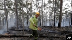 Forestry Corporation worker Dale McLean patrols a controlled fire at a wildfire near Bodalla, Australia, Jan. 12, 2020.