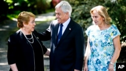 Chilean President Michelle Bachelet, left, talks with president-elect Sebastian Pinera, a former president, as Pinera's wife Cecilia Morel stands by in Santiago, Chile, Dec. 18, 2017.