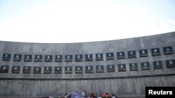 Flowers are seen at the memorial to the victims of the Racak massacre, where ethnic Albanians were killed by Serbian forces in January 1999, in the Racak village, Kosovo, Sept. 22, 2016. 