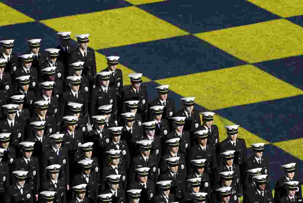 Members of the U.S. Naval Academy stand in formation on the field before an NCAA college football game between Navy and Memphis in Annapolis, Maryland, USA, Oct. 22, 2016.