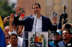 FILE - Juan Guaido, head of Venezuela's opposition-run congress, declares himself interim president of Venezuela, during a rally demanding President Nicolas Maduro's resignation in Caracas, Venezuela, Jan. 23, 2019.