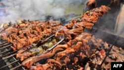 A Pakistani man cooks grilled meat at the Charsi (Hashish) Tikka restaurant in Namak Mandi in Peshawar, Dec. 6, 2018.