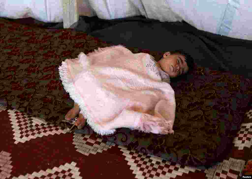 Internally displaced child from Deraa province sleeps inside a tent near the Israeli-occupied Golan Heights, in Quneitra, Syria June 21, 2018.