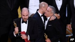 Jordan Horowitz, left, of "La La Land," mistakenly accepts the award for best picture at the Oscars on Sunday, Feb. 26, 2017, at the Dolby Theatre in Los Angeles. It was later determined that "Moonlight," won best picture. (Photo by Chris