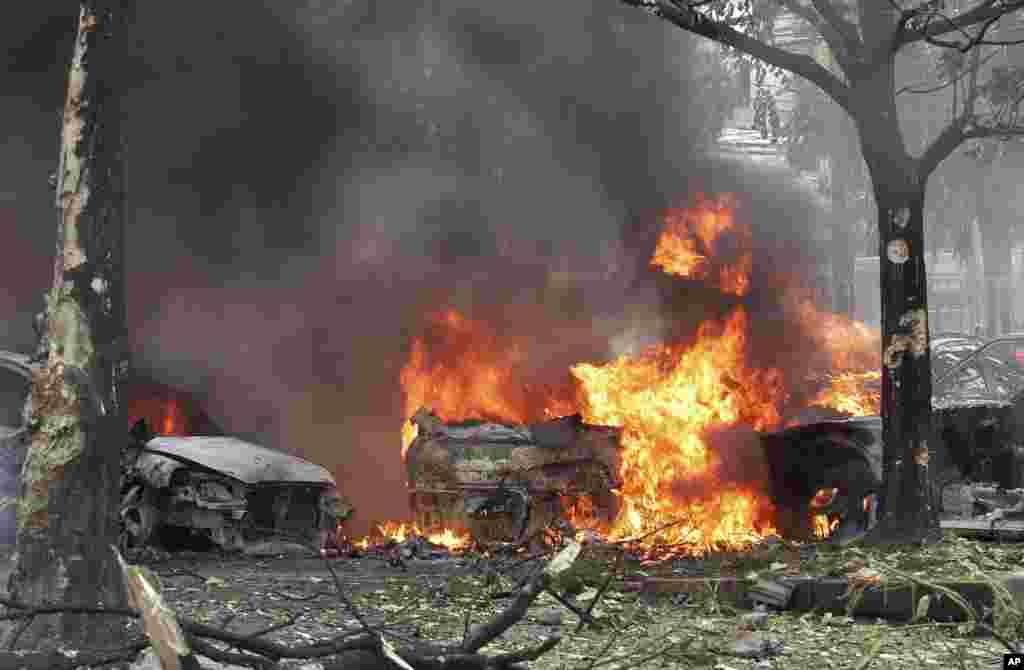 Cars are engulfed in flames after a bomb hidden in a car exploded at a police station parking lot in Hat Yai district in Songkhla province, southern Thailand.