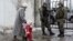 A woman accompanies her child to be evacuated from Avdiivka to Sviatohirsk, a town about 140 kilometers (88 miles) away and far from the conflict front line, in eastern Ukraine, Feb. 5, 2017. A sharp escalation in fighting between Ukrainian troops and Russia-backed rebels in the previous week had killed at least 33 people, centering on Avdiivka, a government-held town just north of rebel-controlled Donetsk.