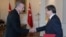 FILE - Turkish President Recep Tayyip Erdogan, left, and Prime Minister Ahmet Davutoglu shake hands, in Ankara, Turkey.