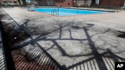 FILE - The swimming pool at Chicago's Altgeld Park remains empty as shelter at home and social distancing orders remain in effect, April 28, 2020. 