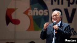 FILE - El Salvador's President Salvador Sanchez Ceren participates in a rally outside the Salvadoran congress building after his third State of the Nation address in San Salvador, El Salvador, June 1, 2017.