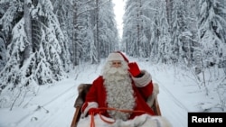 Santa Claus rides in his sleigh as he prepares for Christmas in the Arctic Circle near Rovaniemi, Finland, Dec. 15, 2016. 