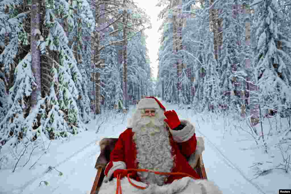 Sinterklas mengendarai keretanya saat bersiap untuk Natal di Lingkaran Arktik di Rovaniemi, Finlandia (15/12). (Reuters/Pawel Kopczynski)