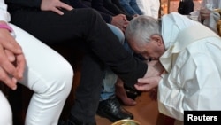 Pope Francis washes the feet of some inmates at the Paliano prison, south of Rome, April 13, 2017. Osservatore Romano/Handout via Reuters.