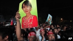 Supporters celebrate as election results are shown on the screen in front of Myanmar's pro-democracy leader Aung San Suu Kyi's National League for Democracy (NLD) head office in Yangon, April 1, 2012.