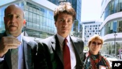 FILE - Agustin Huneeus, center, arrives at federal court in Boston, to plead guilty to charges in a nationwide college admissions bribery scandal,May 21, 2019. Huneeus was sentenced Oct. 4 to five months in prison.