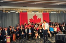 FILE - Canada's Prime Minister Justin Trudeau answers a question about pictures of him in blackface during a town hall meeting at an election campaign stop in Saskatoon, Saskatchewan, Canada, Sept. 19, 2019.