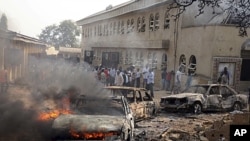 A car burns at the scene of a bomb explosion at St. Theresa Catholic Church at Madalla, Suleja, just outside Nigeria's capital Abuja. Five bombs exploded on Christmas Day at churches in Nigeria, one killing at least 27 people, raising fears that Islamist 