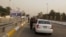 FILE - Iraqi security forces search vehicles at a checkpoint as cars cross into the Green Zone in Baghdad, Iraq, Oct. 5, 2015. The zone houses government buildings and foreign embassies, including that of the United States.