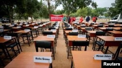 FILE - Names of missing Chibok schoolgirls kidnapped by Boko Haram in 2014 are displayed on the fifth anniversary of their abduction, in Abuja, Nigeria, April 14, 2019. One captive, Hassana Adamu, was freed this week, officials said Aug. 14, 2021.